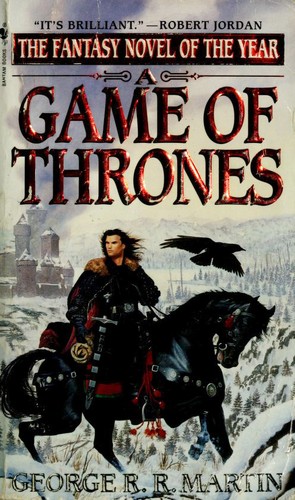 A Game of Thrones book cover, a mounted knight and raven against a snowy castle backdrop